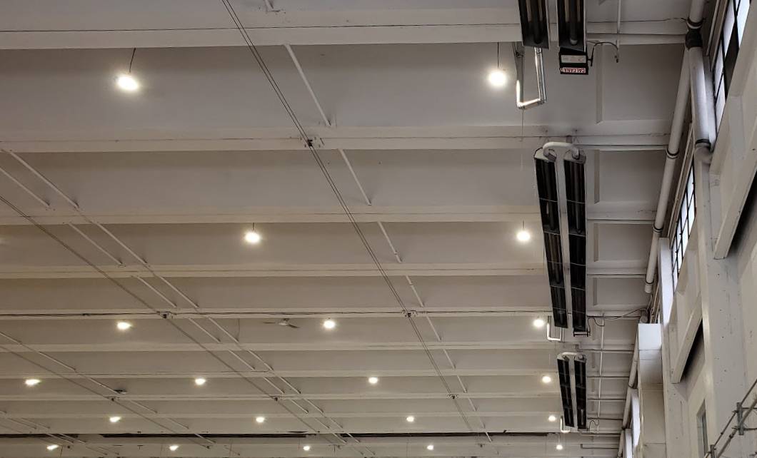 Commercial warehouse hanger lights, motion sensor lighting, ceiling fans, and fire alarm installations by First Aid Electric.
