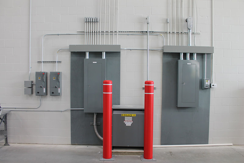 Commercial warehouse  electrical panel, transformer, conduit & wire, lighting, emergency lighting, and fire alarms Commercial warehouse hanger lights, motion sensor lighting, ceiling fans, and fire alarm installations by First Aid Electric by First Aid Electric.