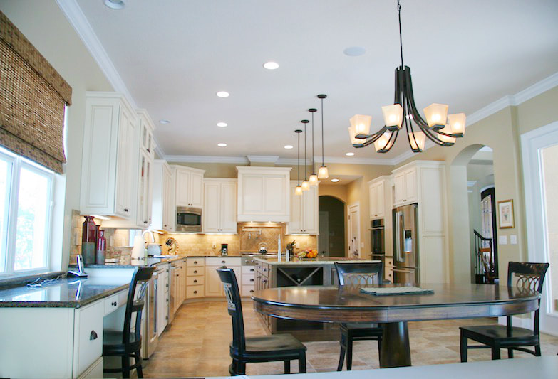 Kitchen pendant lights, dining lights, recessed lights, under cabinet lights, and sound system installation by First Aid Electric.